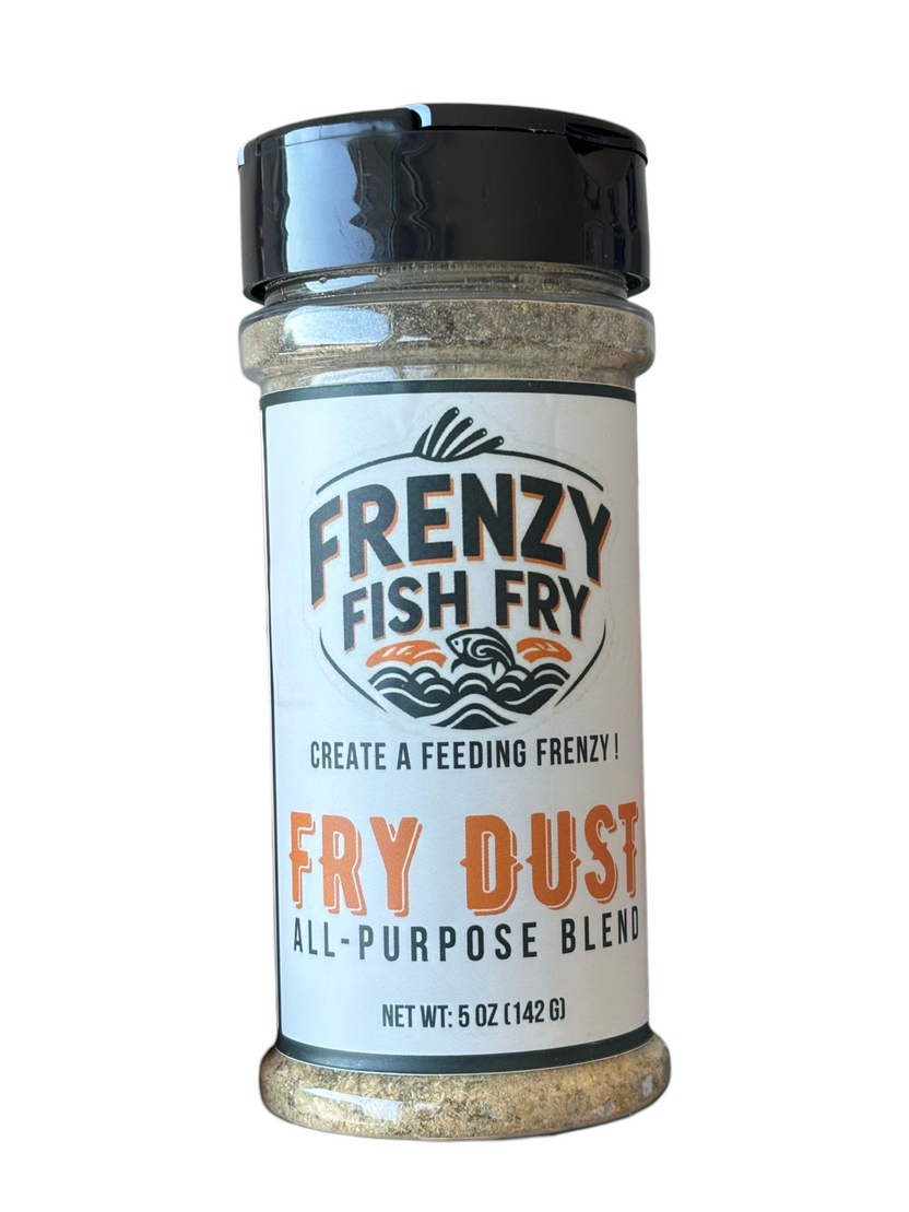 Close-up of Fry Dust All-Purpose Seasoning label by Frenzy Fish Fry showing garlic, oregano, and citrus spice blend packaging design.