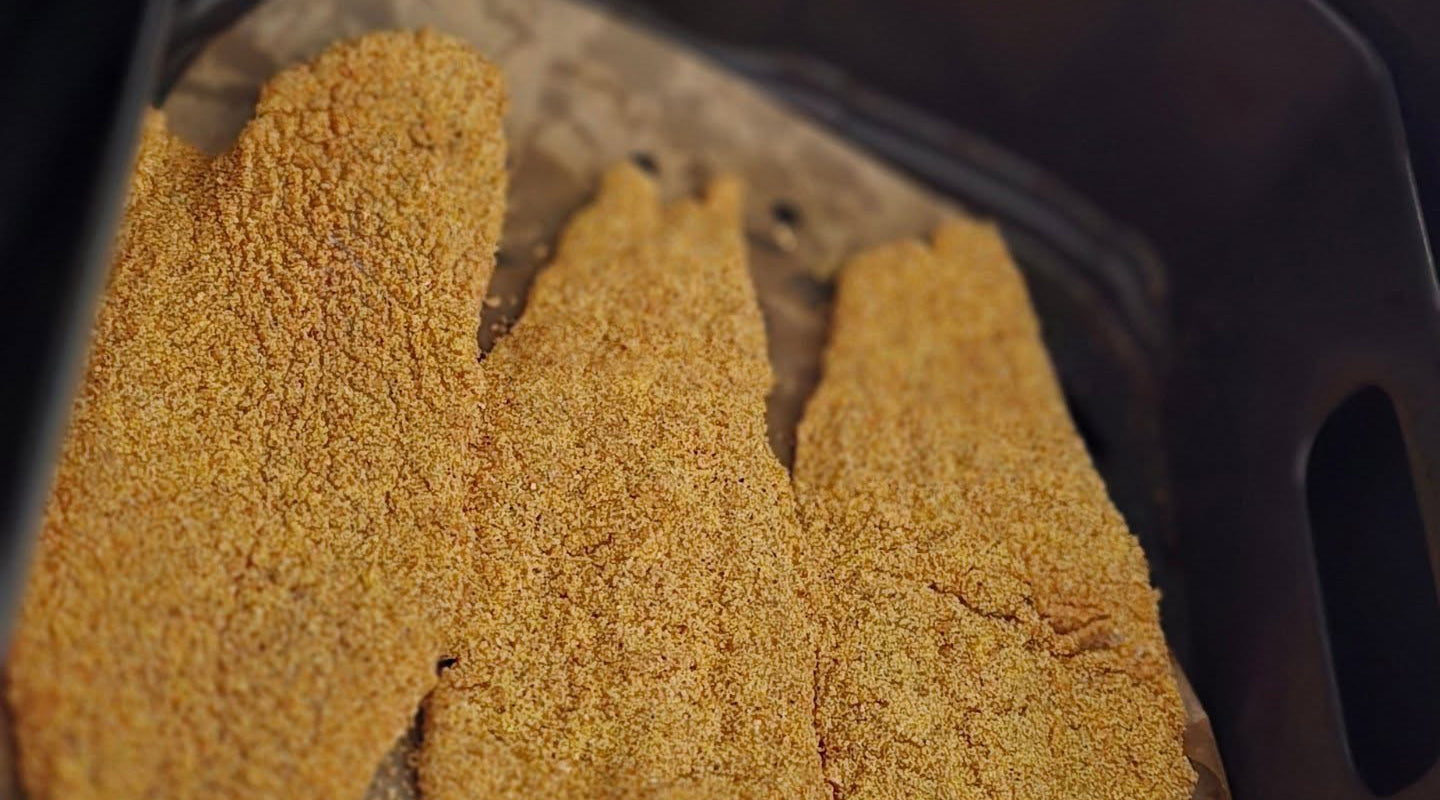Golden crispy air fryer fish fillets made with Frenzy Fish Fry Mix